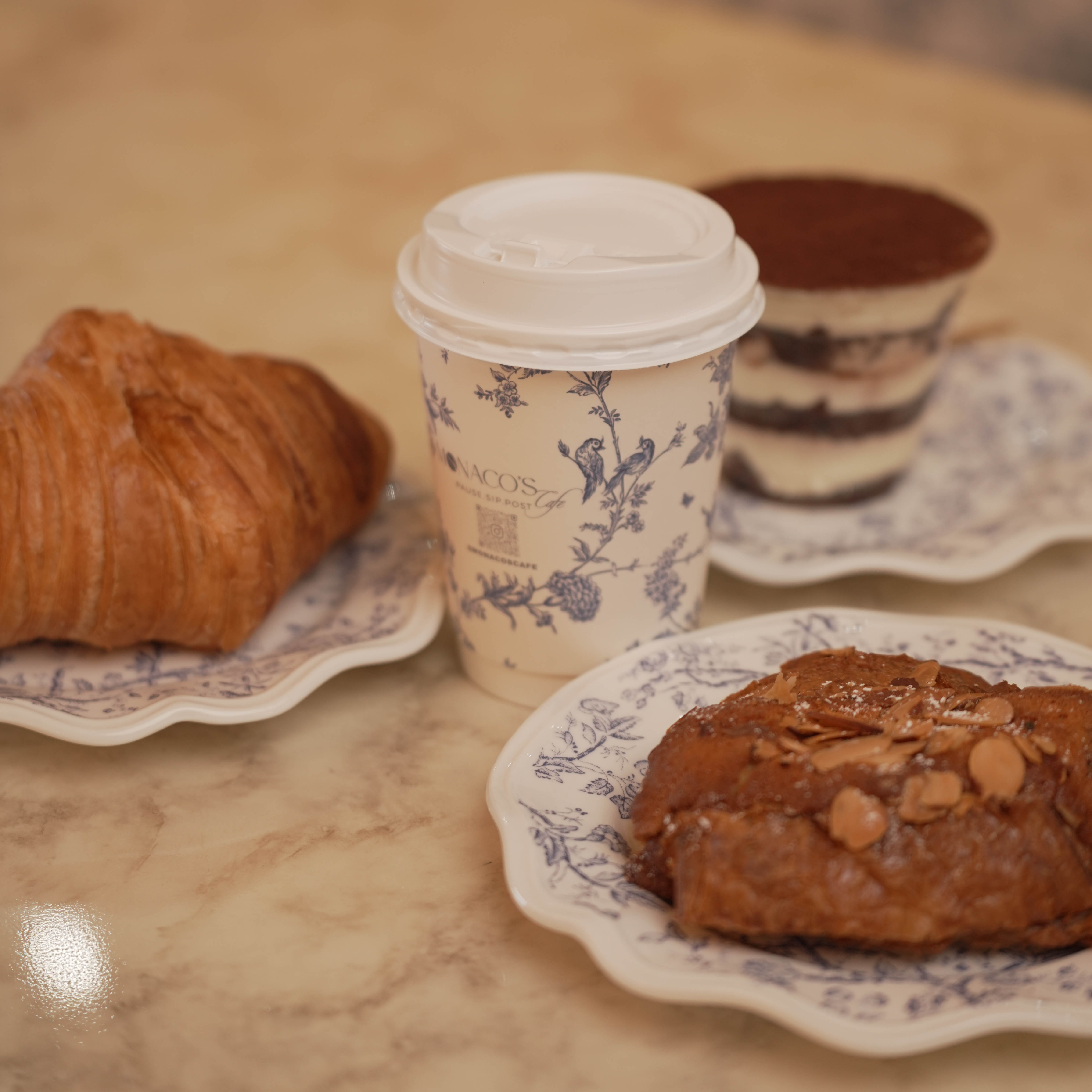 Coffee with a croissant, tiramisu and a cookie at Monaco's Cafe